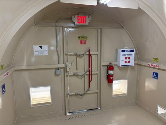 Interior egress door, emergency equipment, and safety features in a Safe-T-Shelter Mobile Platform Based Shelter